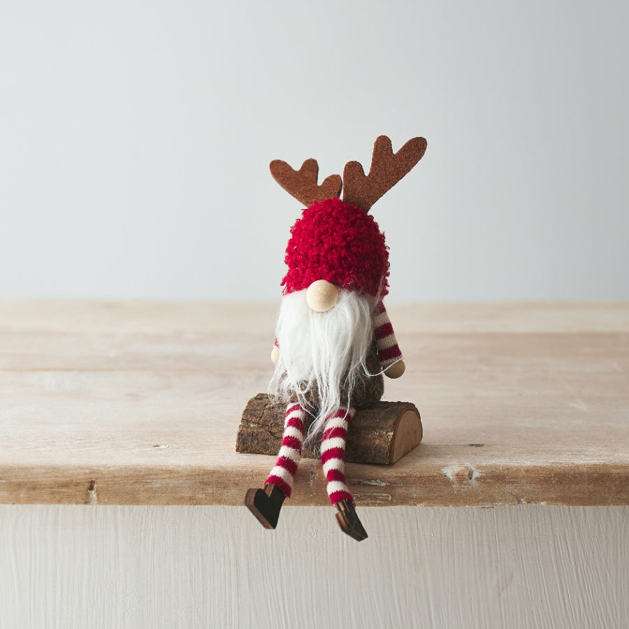 Red Woodland Gonk Sitting On A Log